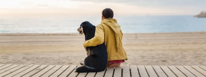 Dealing With Pet Loss - Pet Bereavement owner and dog gazing out at the ocean