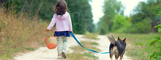Helping Children Cope With Losing a Pet Image of a child and a dog for article on how to help children cope with losing a pet
