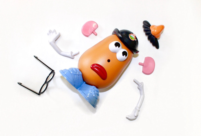 A top down view of a MrPotato Head in pieces.