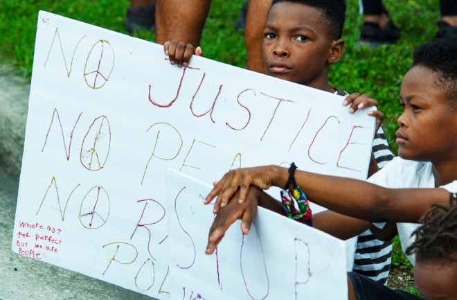 protest child sign racism - shutterstock