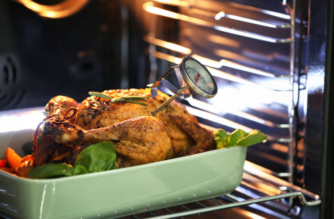 Turkey roasting in the oven with a meat thermometer