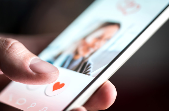 online dater favoriting a profile on dating app - shutterstock