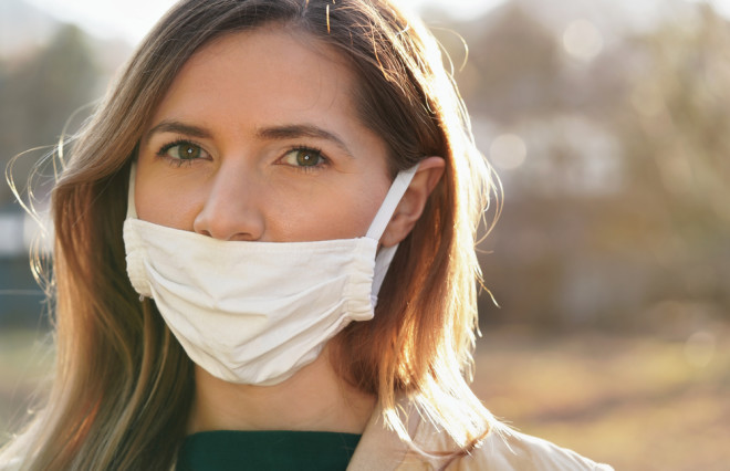 woman wearing mask improperly with nose exposed - shutterstock