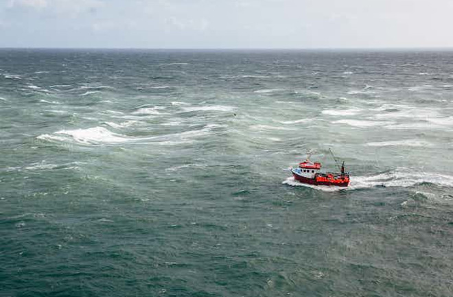 red-fishing-boat-at-sea