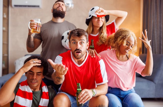 Angry sports fans watching game on TV