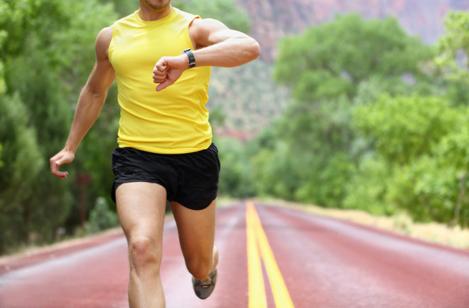 Man running with a digital heart rate tracker