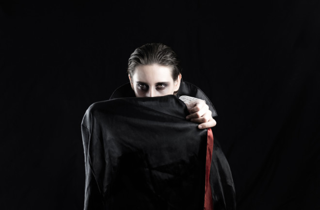 Vampire hiding behind a cloak