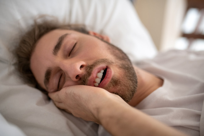 man sleeping with mouth open - shutterstock 1623832186