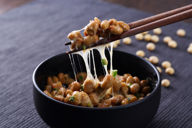bowl of natto with chopsticks - shutterstock 1140852635