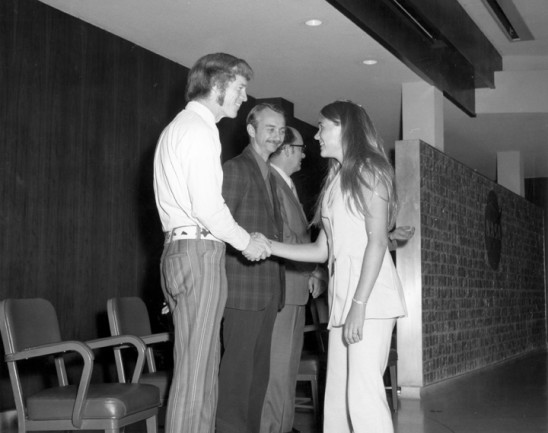 Student Kathy L. Jackson wearing pants as she greets Astronauts and MSFC Personnel(L-R); ASTRONAUTS Rusty Schweickart, Owen Garriott, and MSFC Skylab Program Manager Leland Belew. NASA/MSFC