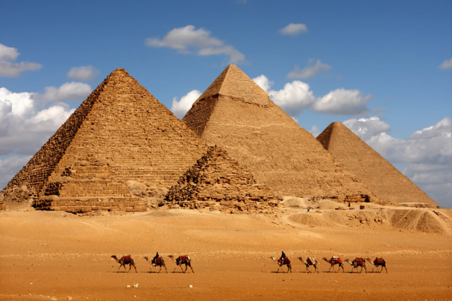 pyramids in eqypt with camels - shutterstock