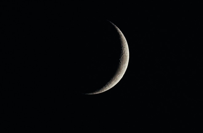 A waxing crescent moon, around three days into the cycle of moon phases.