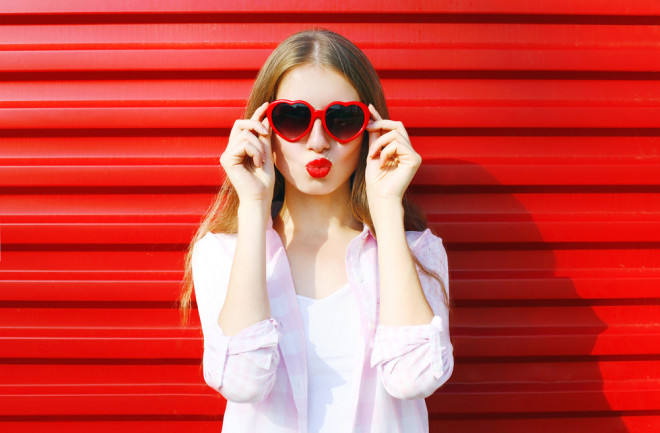 woman wearing red lipstick and heart sunglasses - shutterstock 407717485