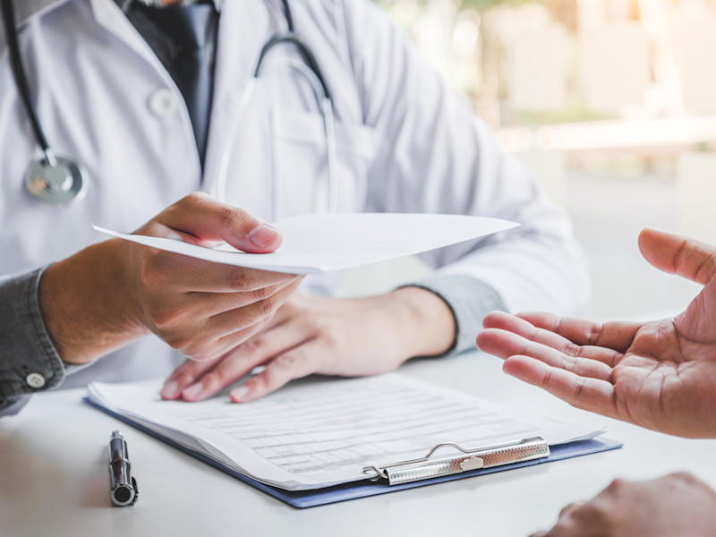 Nurse hiring manager holds a candidate's cover letter for a nursing job.