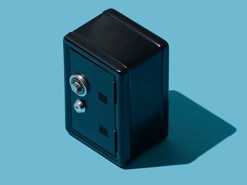 Black safe against a blue backdrop