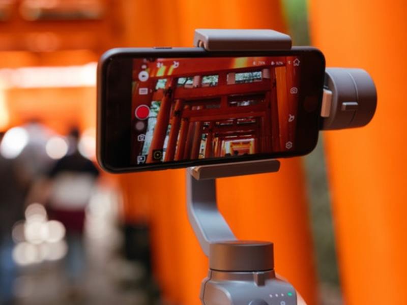Smarphone on a tripod taking video of a local art installation