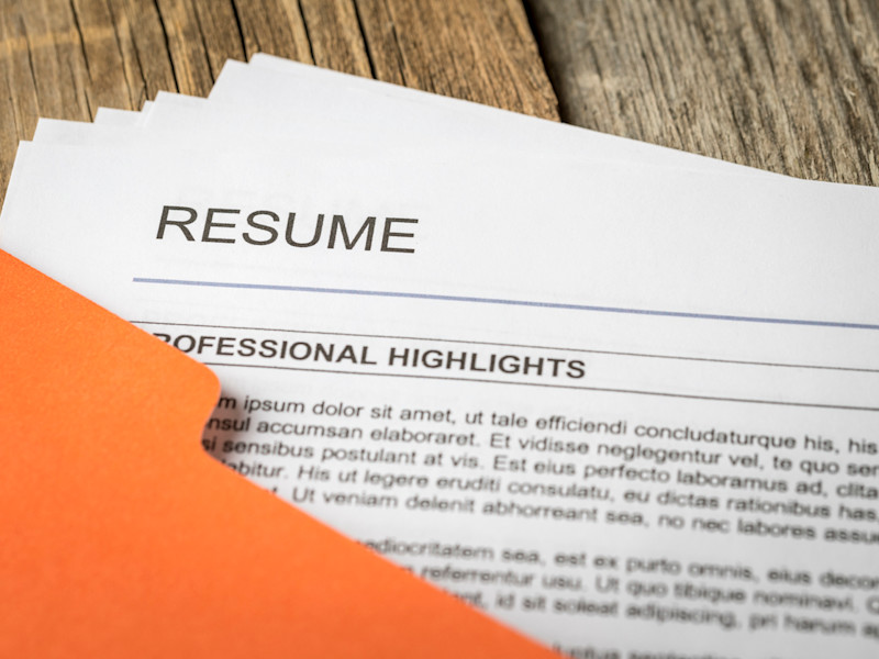Orange manilla folder full of dentist resumes.