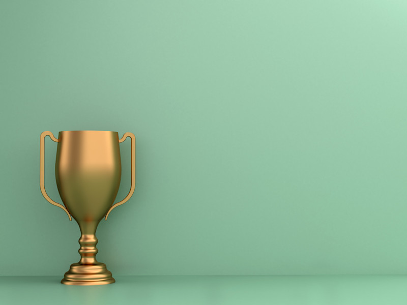 Yellow trophy against a mint green backdrop