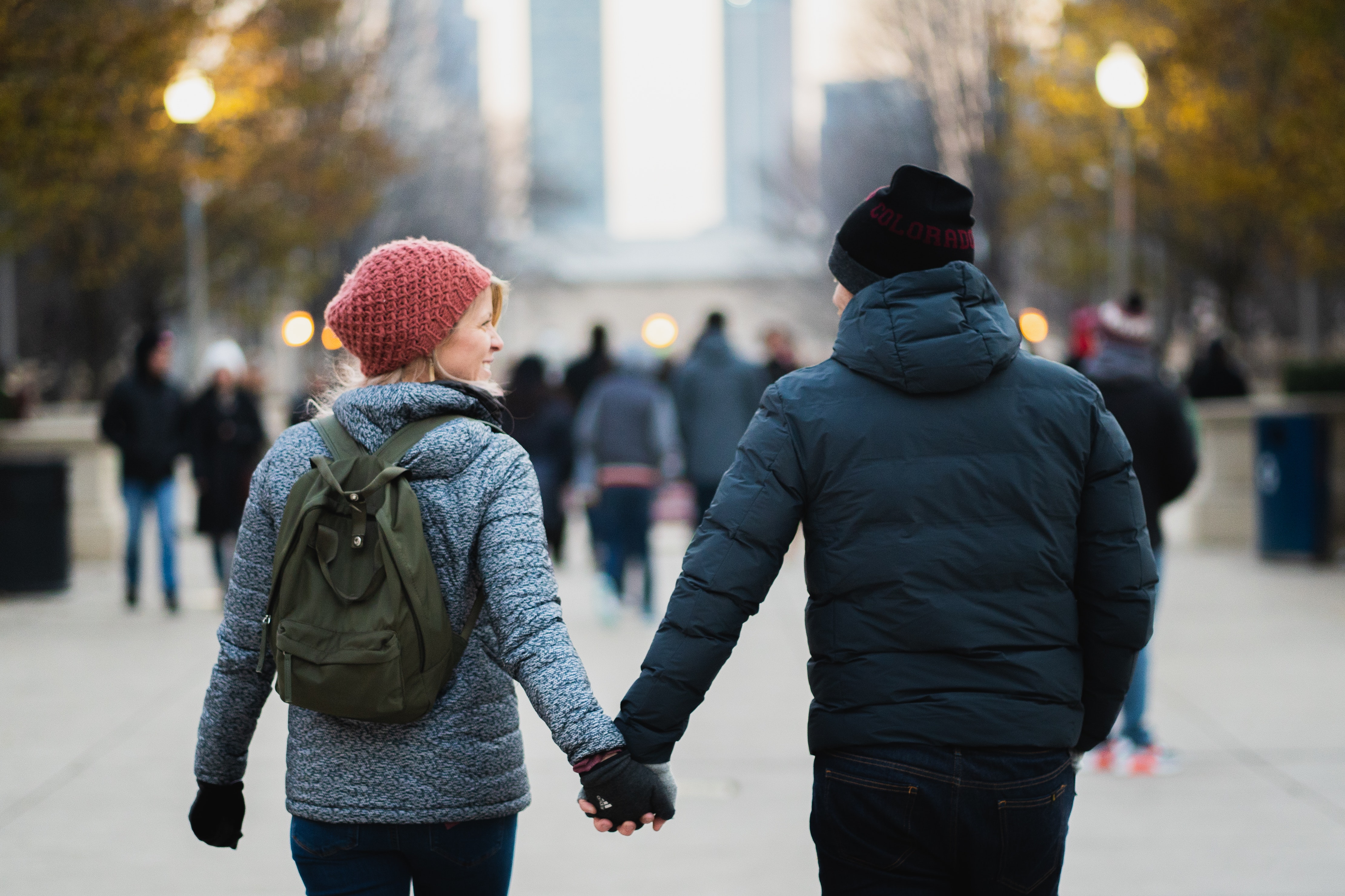 A couple holding hands walking in the park