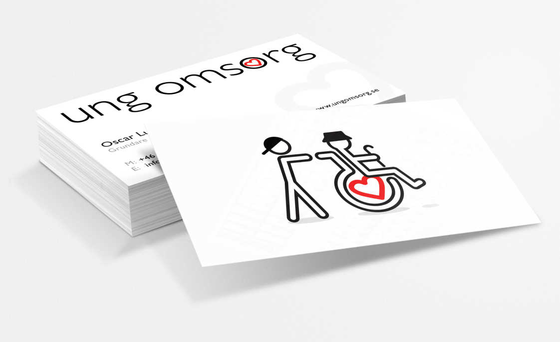 White business cards featuring boy pushing an old man in a wheelchair. The wheel of the wheelchair has the heart icon from the logotype.