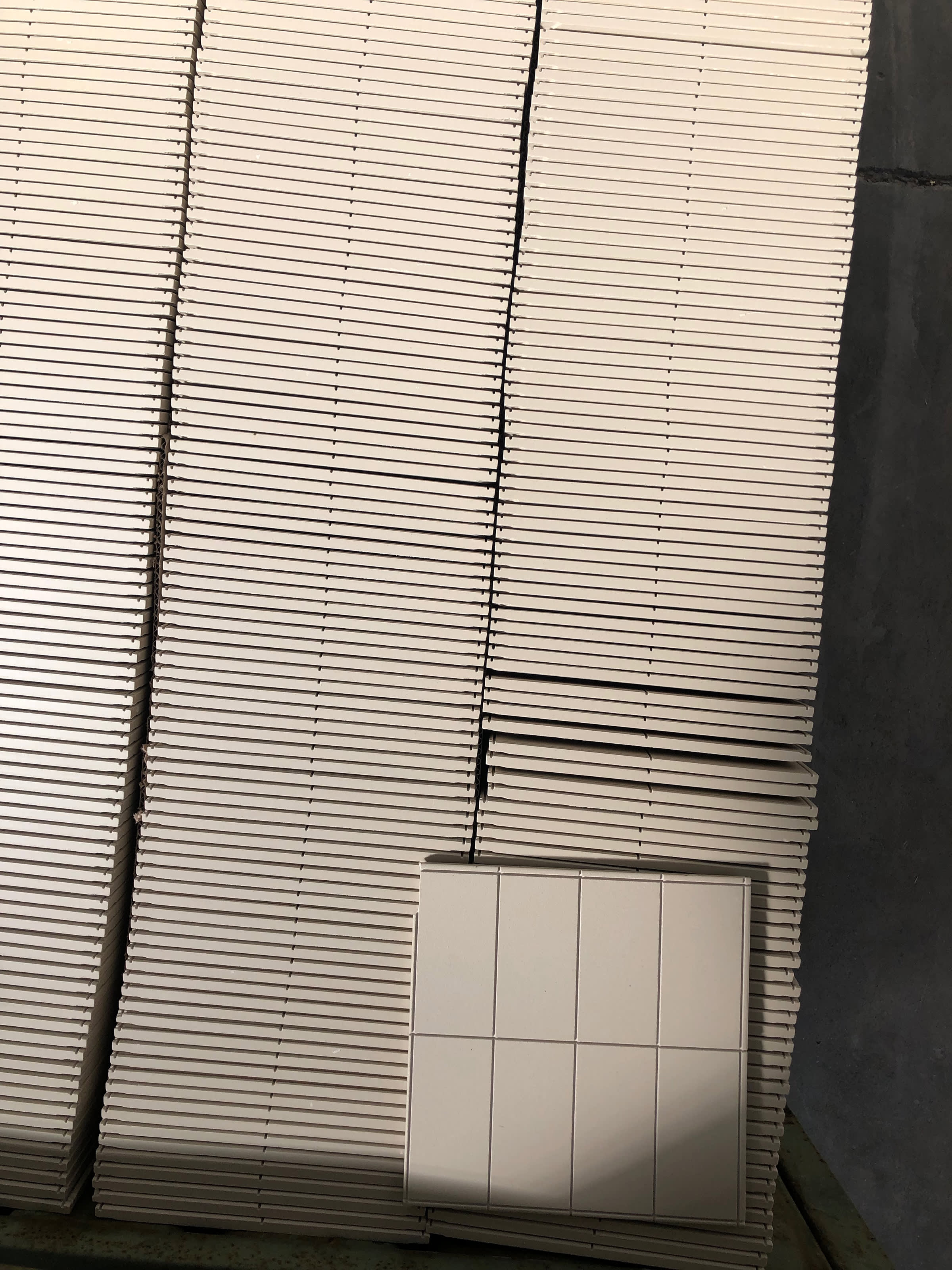 Gris porcelain biscuit before glazing and cutting.