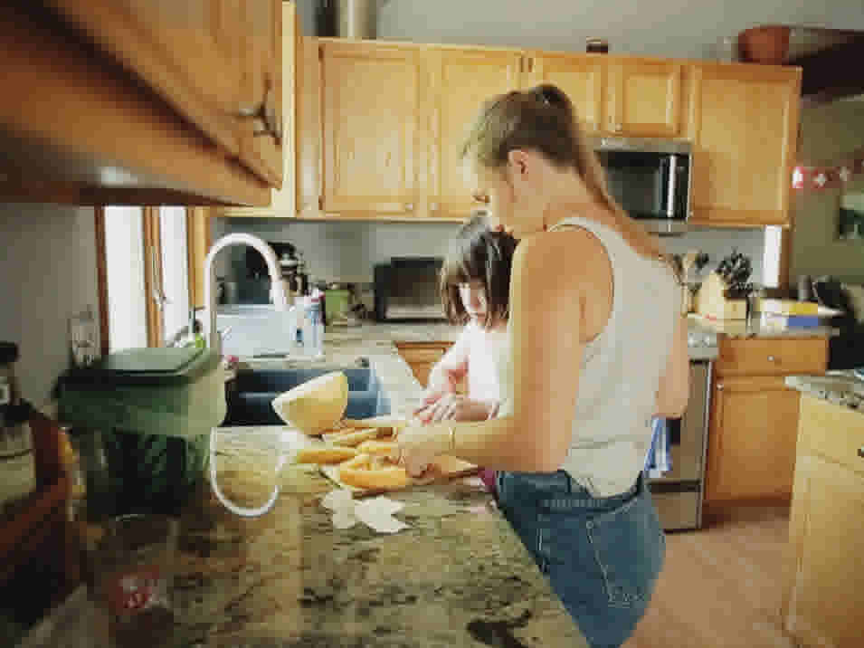 Flo's preparing snack for the children and helping kids with their homework
