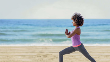 Mujer afroamericana haciendo ejercicio en la playa