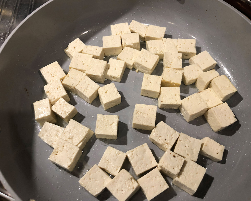 cooking tofu on a ceramic pan