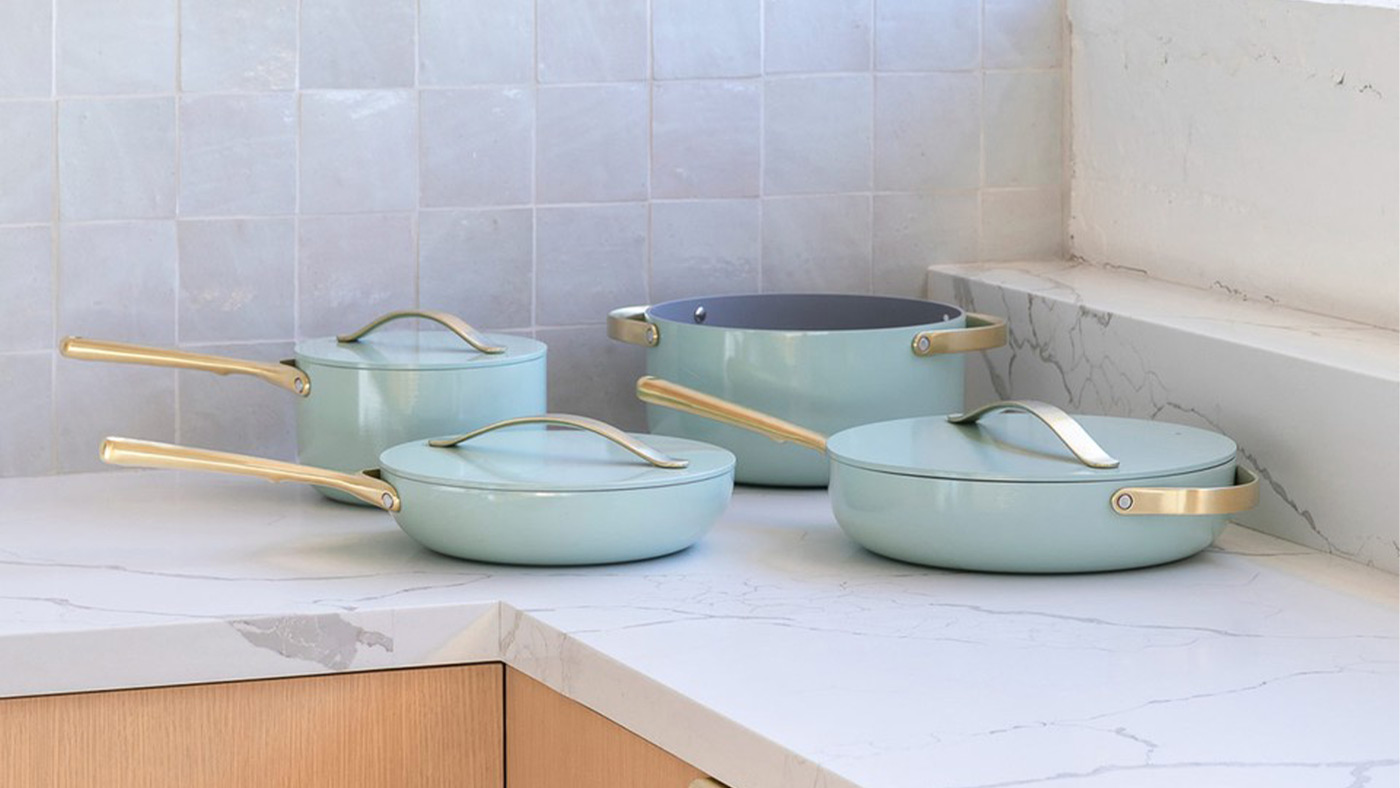 A teal blue Caraway ceramic nonstick cookware set that is great for roasting