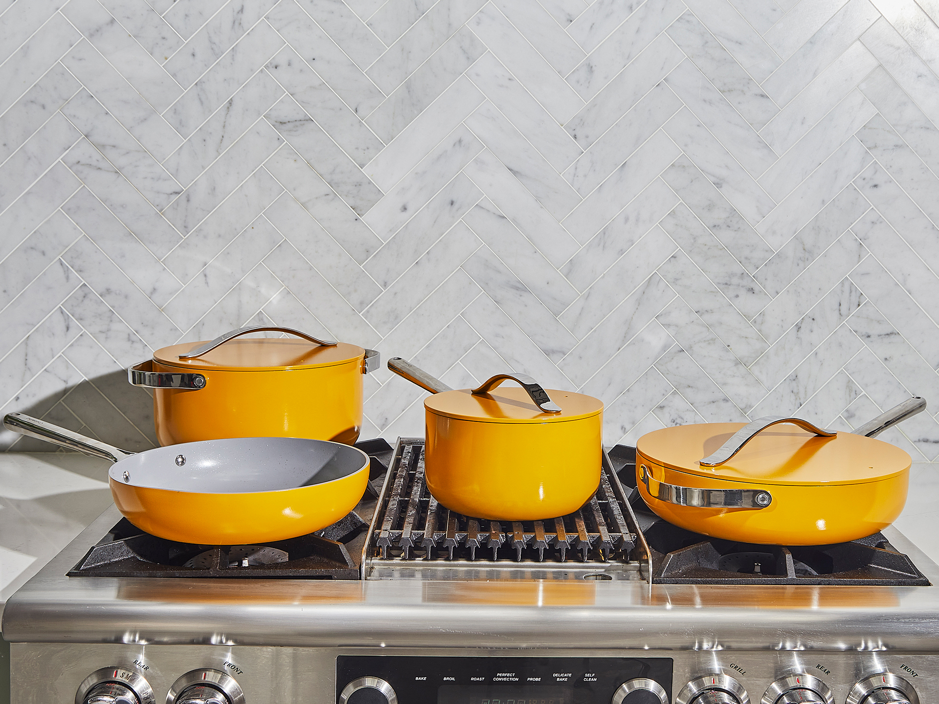 Marigold ceramic cookware resting on a stove top