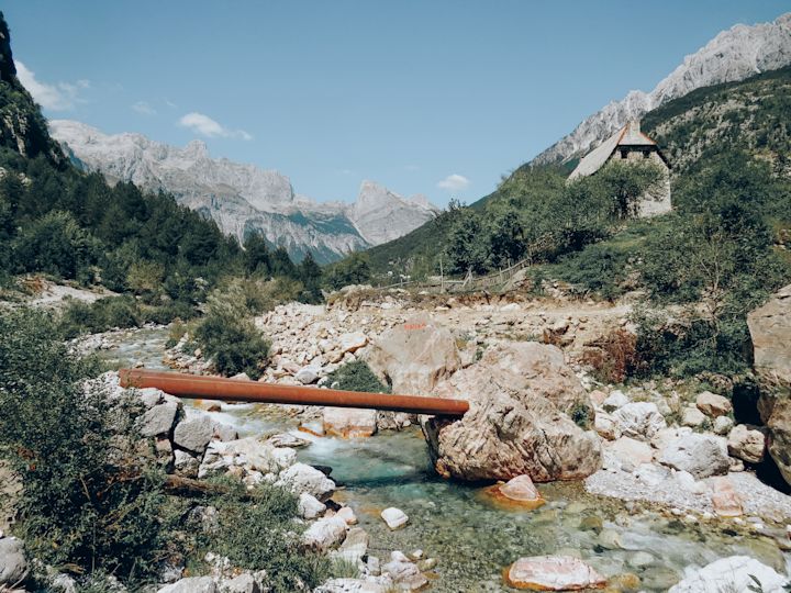 A babbling brook snakes through the valley