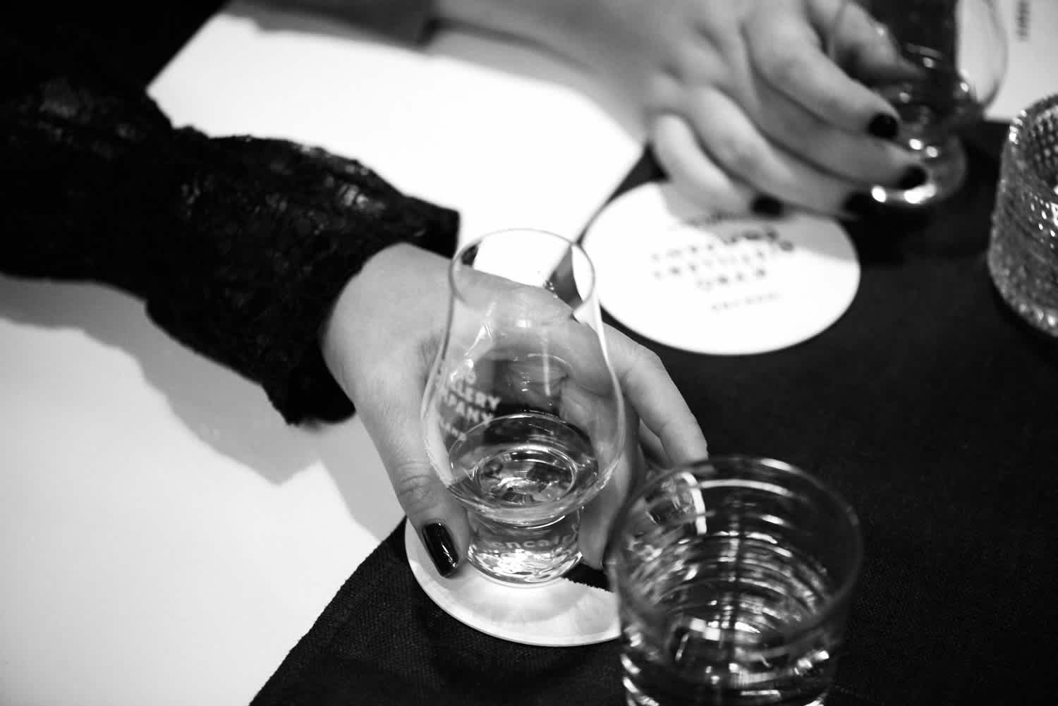Woman holding a whisky tasting glass.