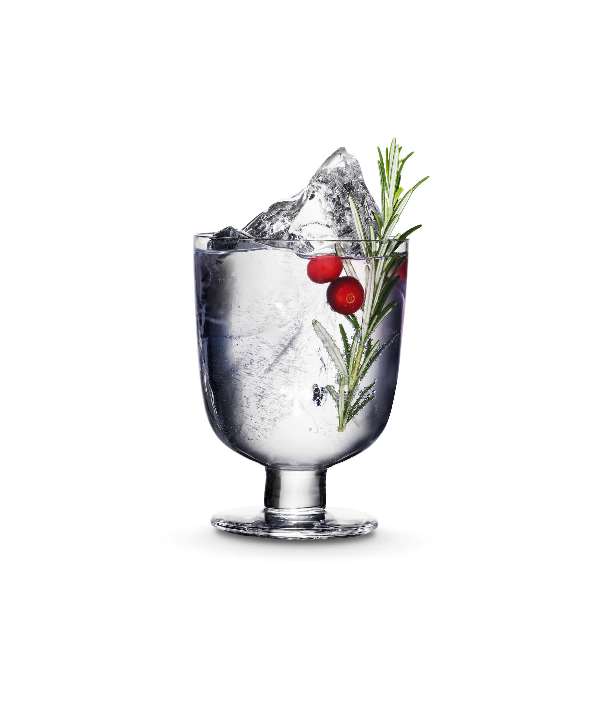 Kyrö Gin & Tonic: a cocktail glass filled with Kyrö Gin, Fever-Tree Indian Tonic Water, cranberries, rosemary, and hand-cut ice. 