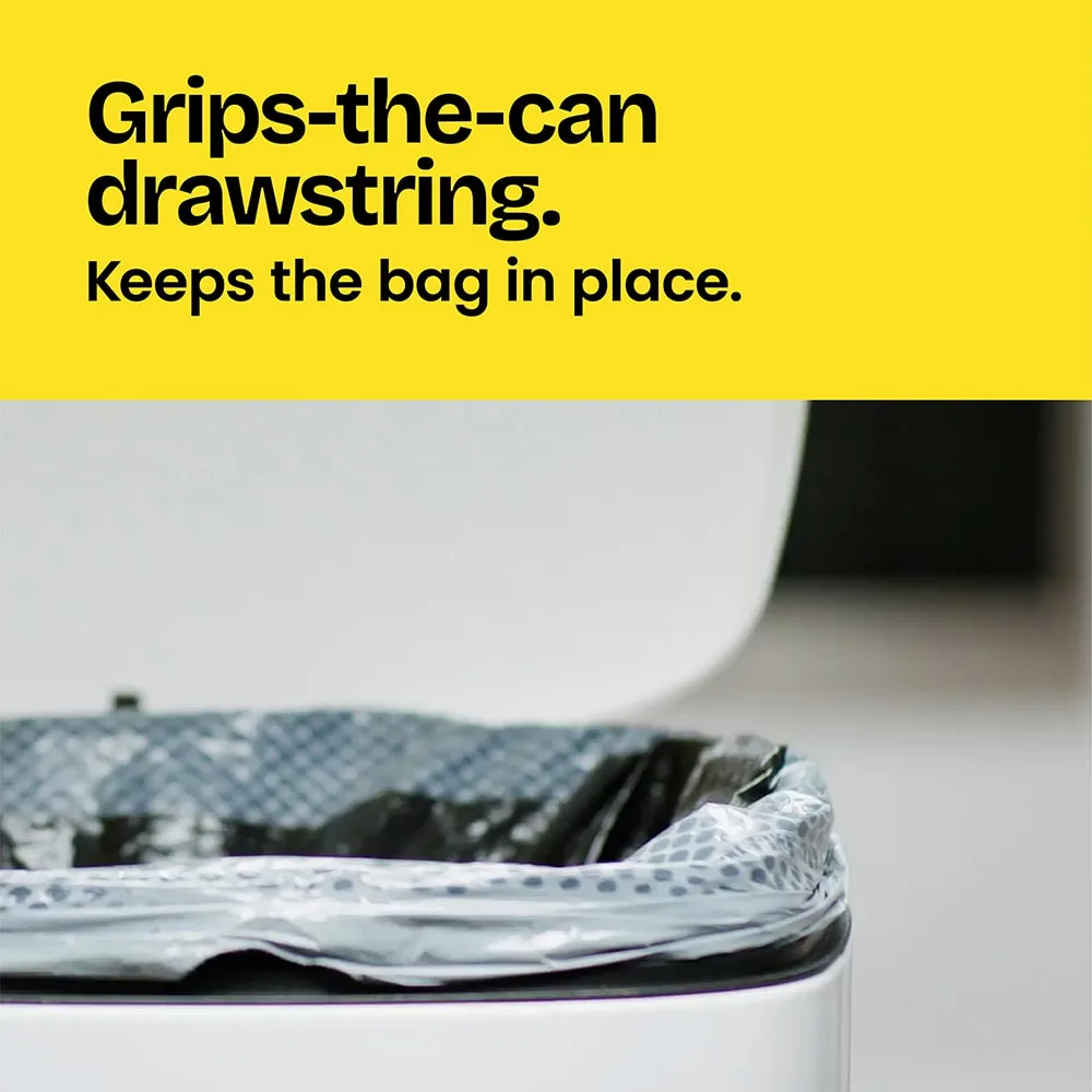 A gray trash bag in a trash can showing the grip strength of the bag. The words "Grips-the-can drawstring. Keeps the bag in place." on a yellow background above.