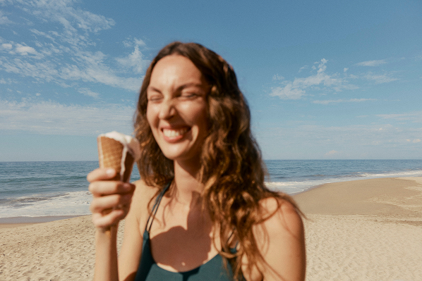 Woman with icecream on beach