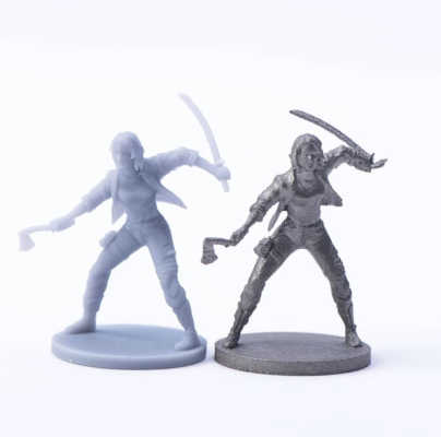 3d printed miniatures in resin and metal side by side