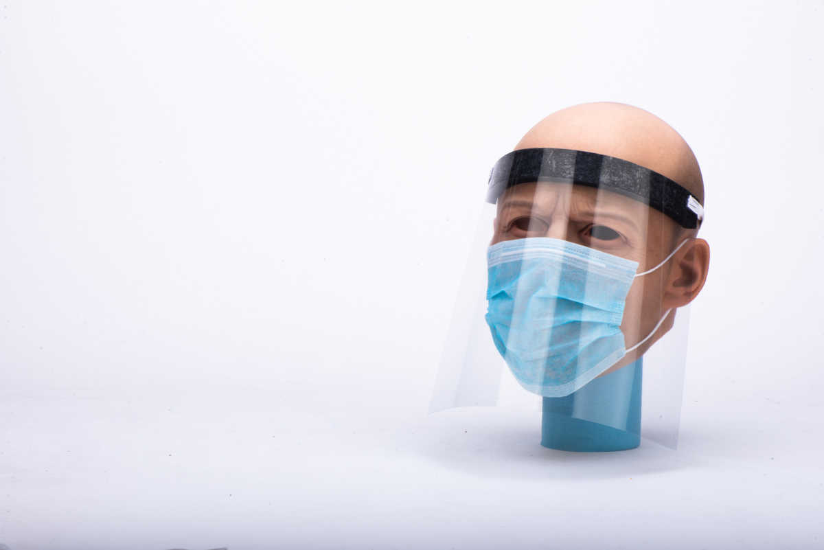 A mannequin wearing a homemade face shield