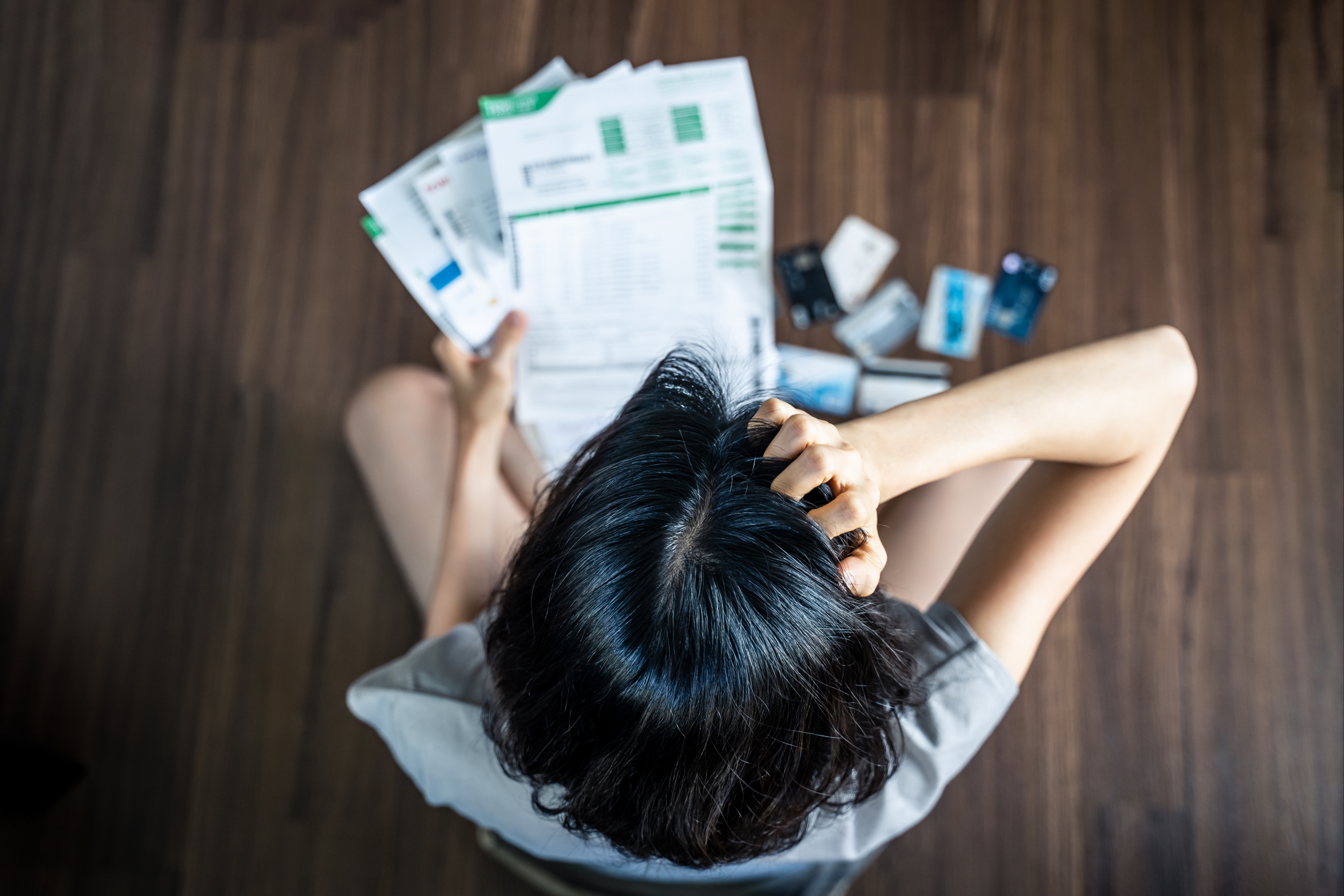woman-looking-at-paperwork-stressed