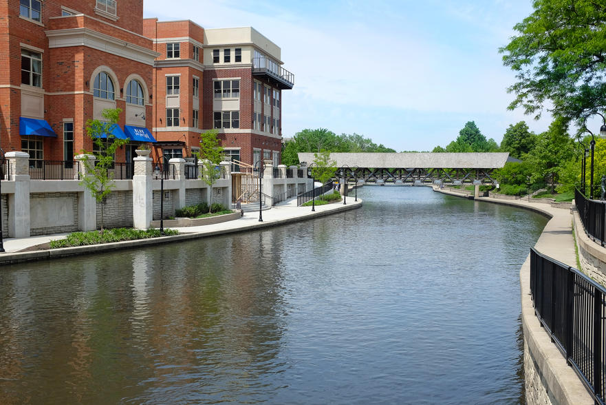 The Healthiest Cities in the United States for Families - Waterfront walkway in Naperville, IL against a blue sky.