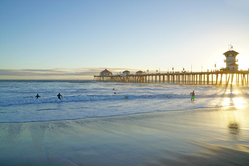 The Healthiest Cities in the United States for Families - Pier in Huntington Beach, CA during sunrise. 