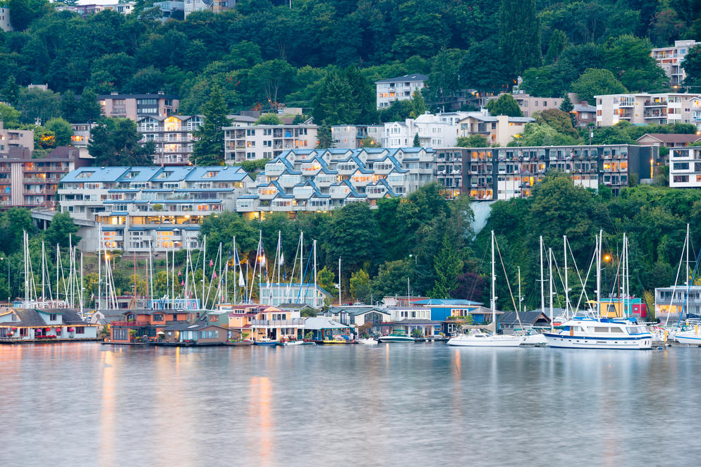 The Healthiest Cities in the United States for Families - Boats anchored along the coast in Seattle, WA with lush mountains in the background. 