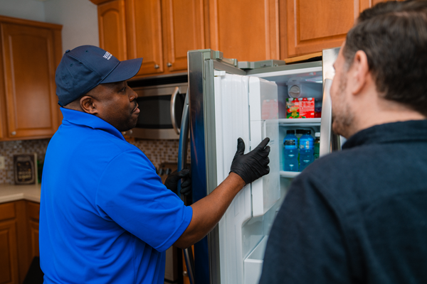 technician-fixing-a-kenmore-refrigerator-not-cooling