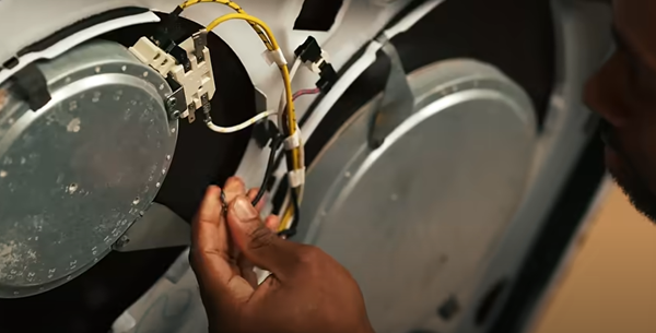 sears-home-services-tech-repairing-a-range-burner