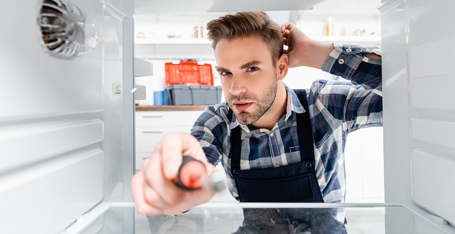 homeowner-deciding-whether-he-can-fix-his-fridge-himself