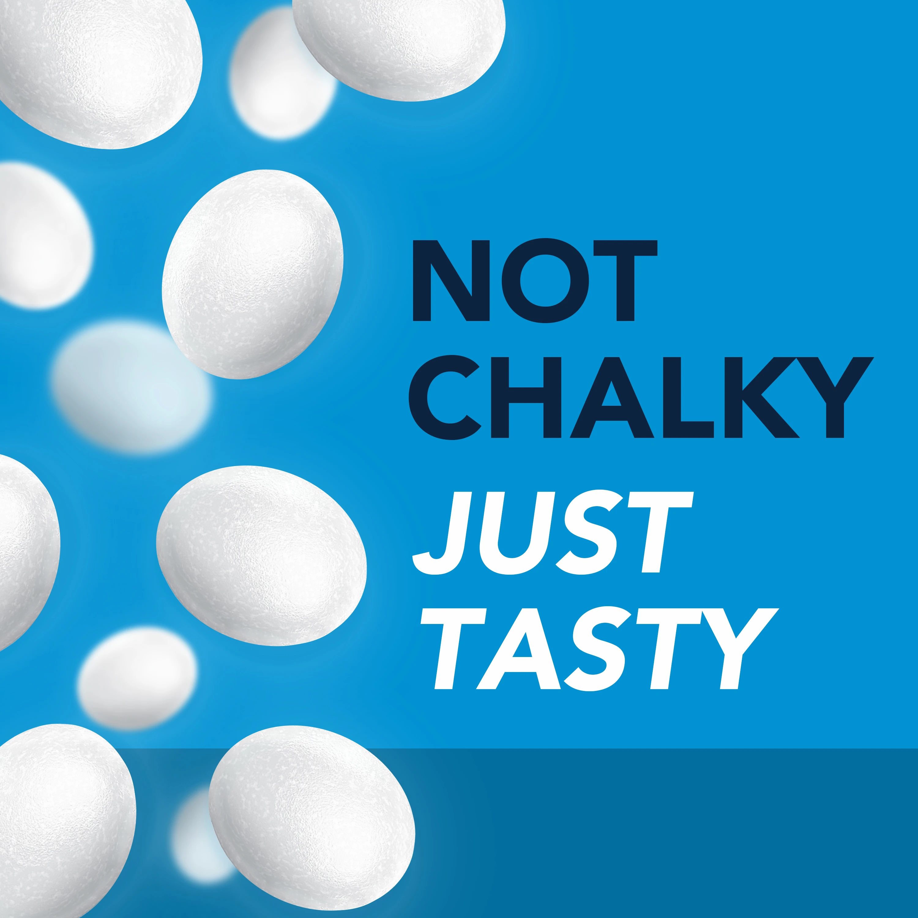 Text on a blue background "NOT CHALKY JUST TASTY" surrounded by many white lozenges.