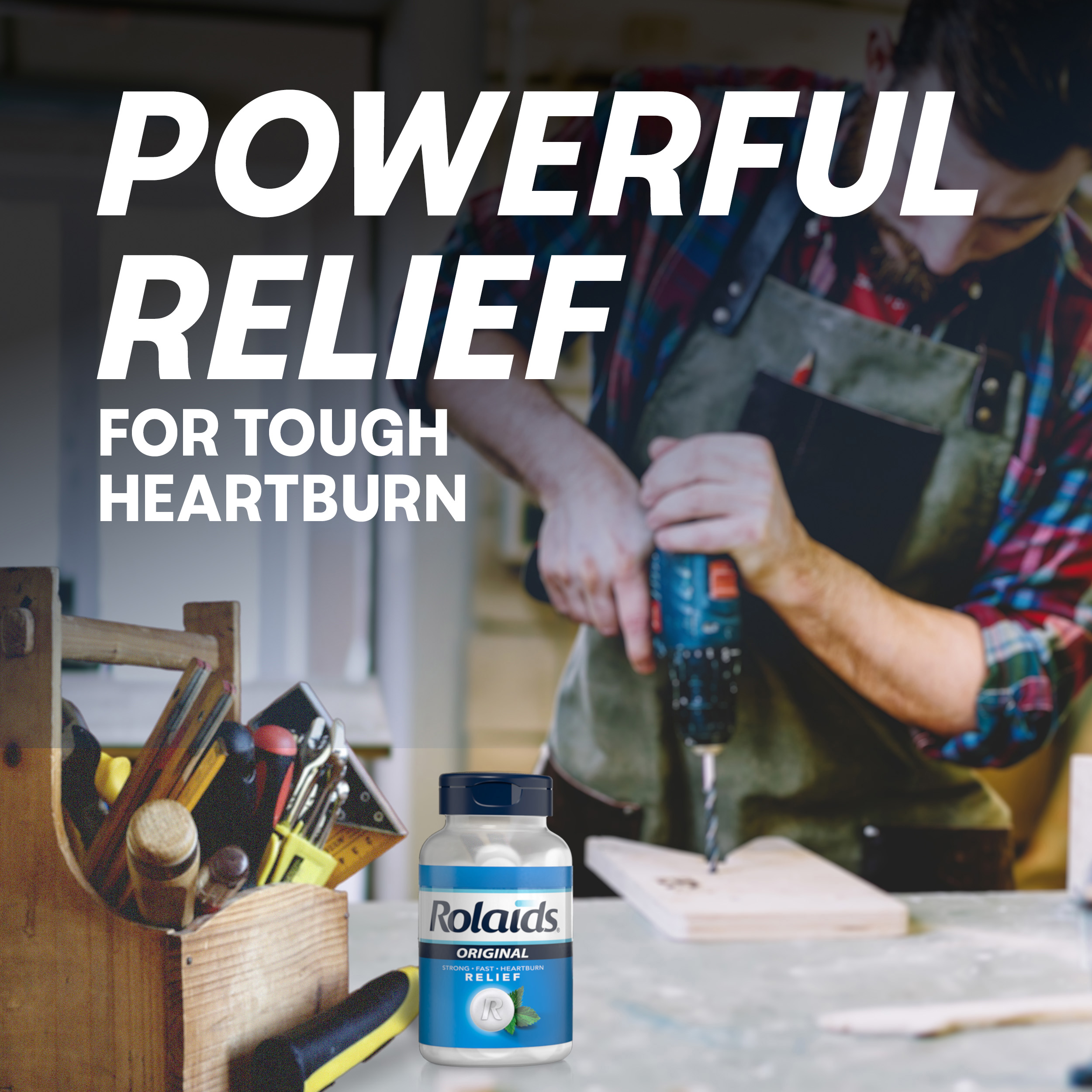 A man using a power drill in a workshop with a Rolaids bottle in the foreground and text reading "Powerful relief for tough heartburn."