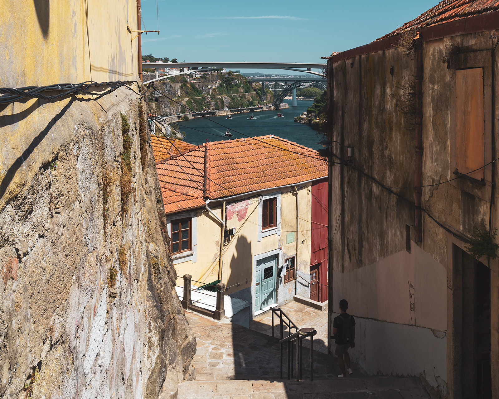 Porto old town alley and view of the Ponte Infante Dom Henrique