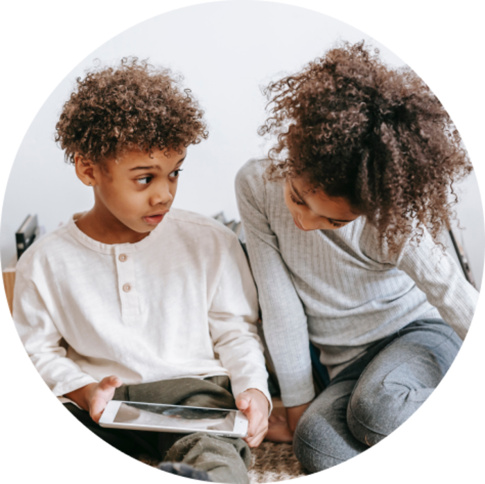 Kid reading on the phone with his mother