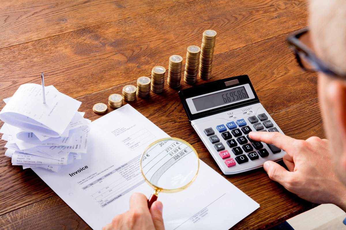 Auditor Hand Checking Invoice