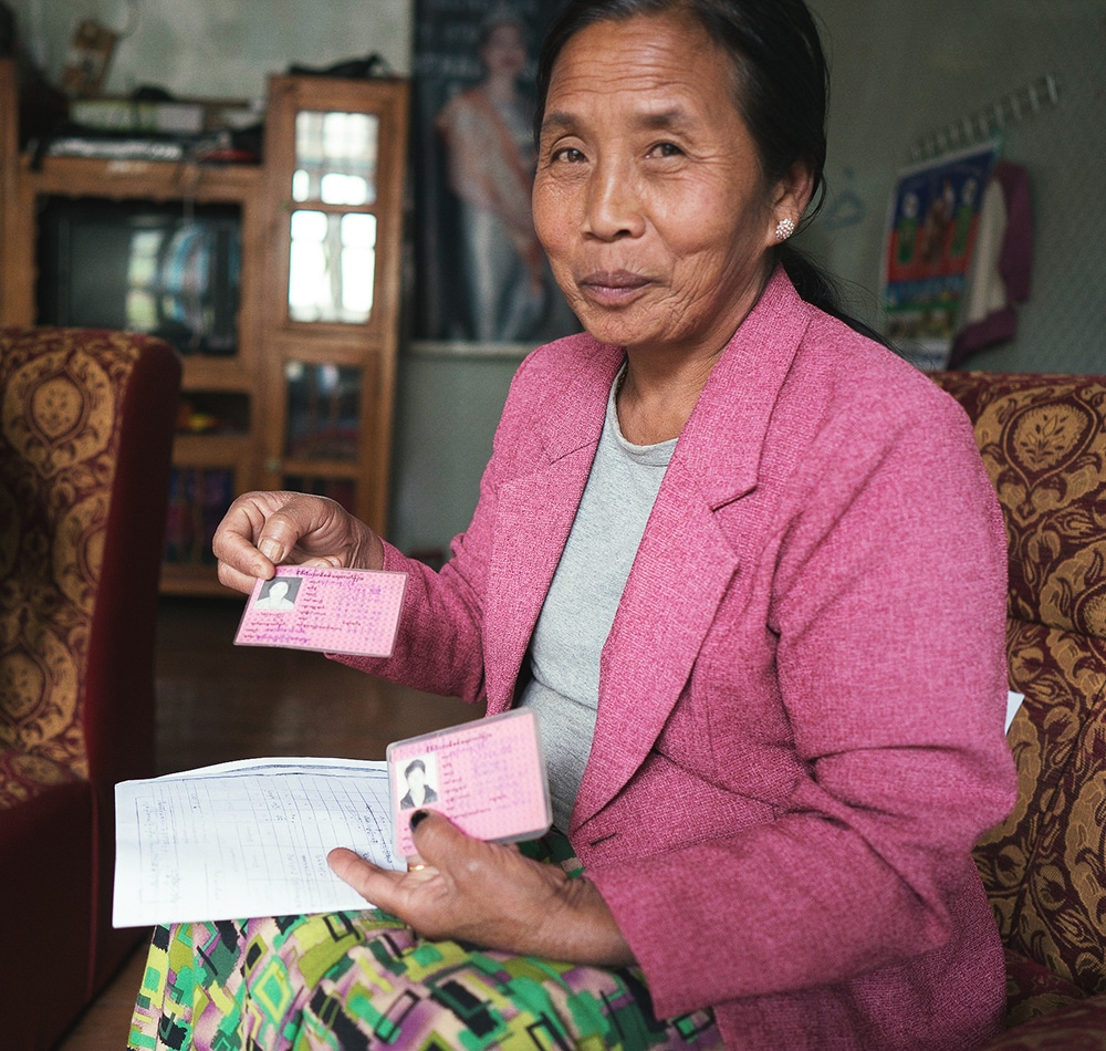 A Myanmar women showing her identification papers